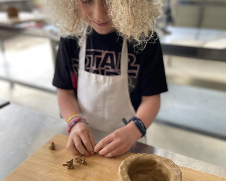 child making figures with clay